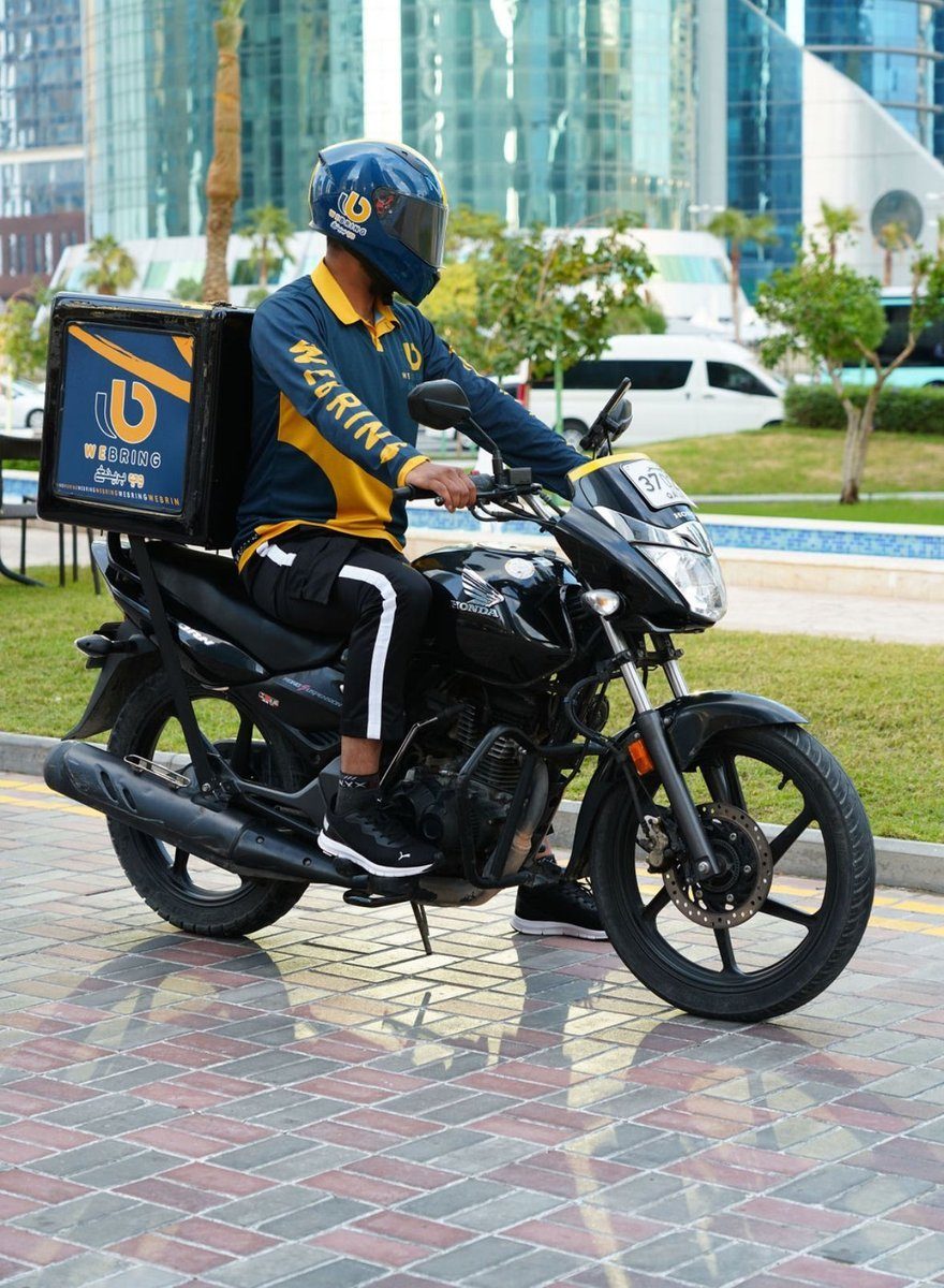 A We Bring Delivery rider on the road in Doha, Qatar